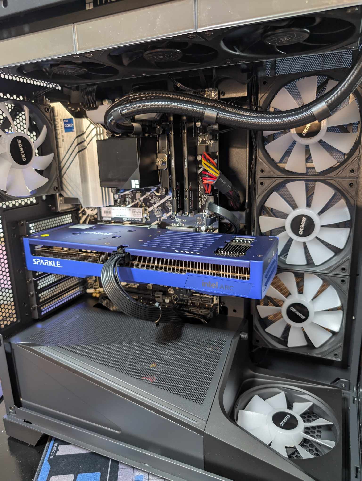 Sparkle Intel Arc graphics card installed in a custom PC build with white RGB fans