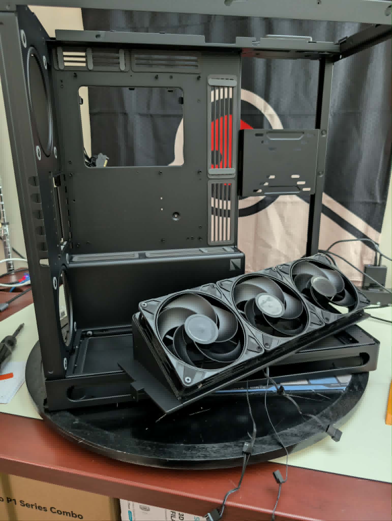 PC case mid-assembly with radiator fans and internal panels laid out