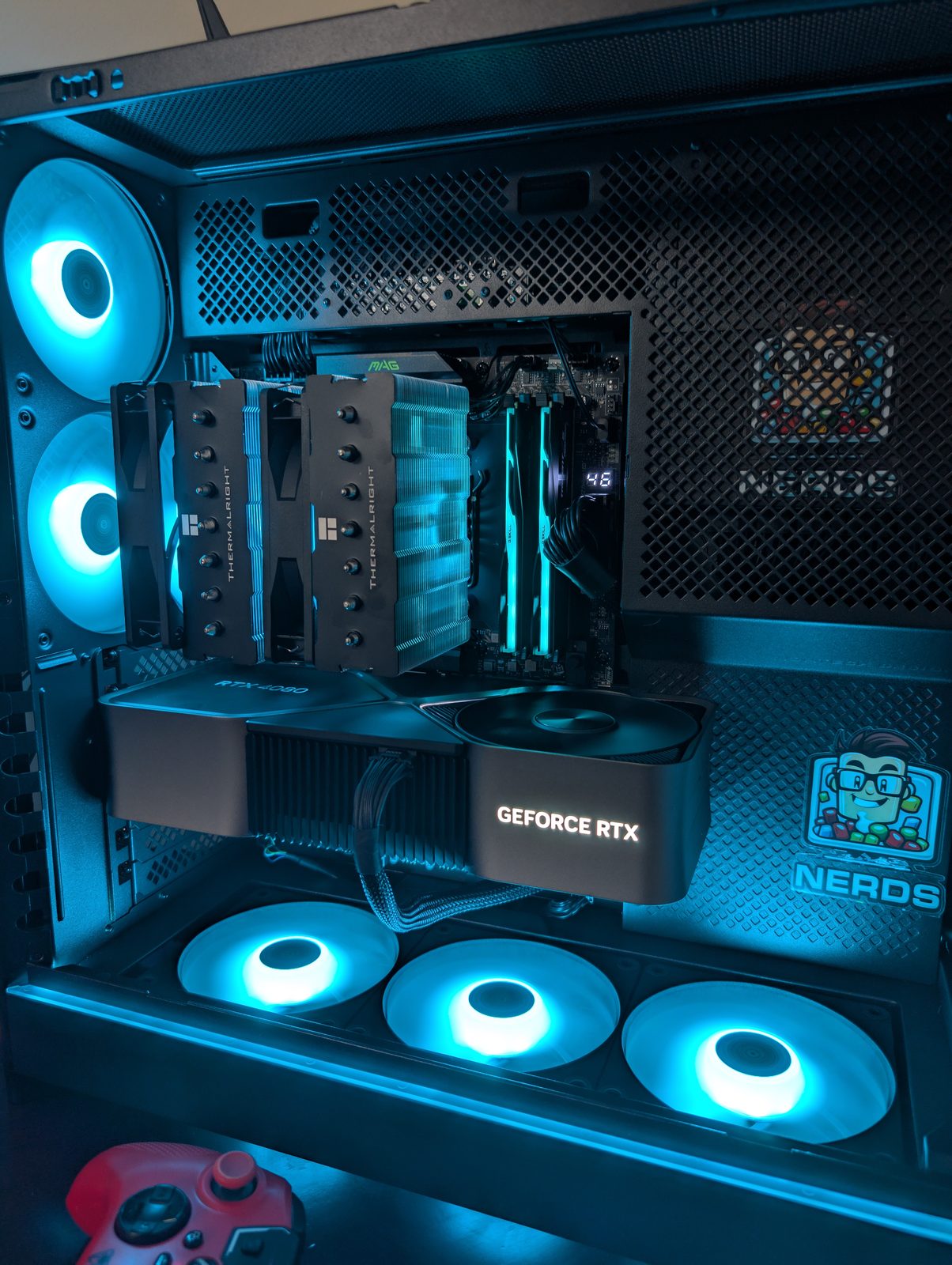 AMD Ryzen 7 9800X3D custom build with orange RGB fans and live system stats panel